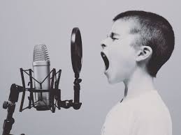 Child singing passionately into a microphone.